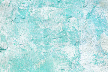 Vintage, old stucco plaster surface background, close up rough texture of turquoise and white mixed...