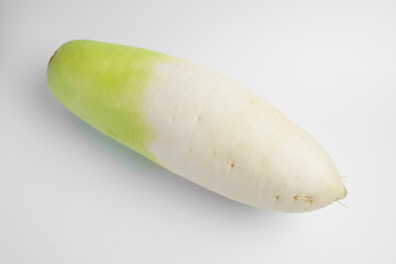 One radish root neatly arranged on a white background