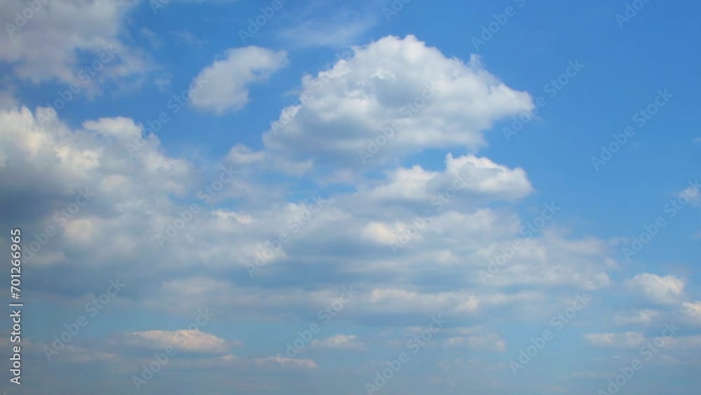 Wall mural large cumulus clouds float forward towards the camera and change their shape. the sky is covered wit