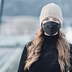 Woman with red long hair, blue eyes, young with FFP2 mask, wearing beige cap and black sweater,...