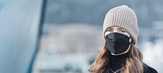 Woman with red long hair, blue eyes, young with FFP2 mask, wearing beige cap and black sweater, head portraits