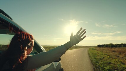 girl rides car with her hand out window, outdoors vacation, beautiful girl sticking out hand from...