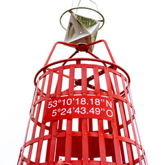 Geograpic  longitude and latitude coordinates on a red fairway buoy, degrees, gps coordinates,...