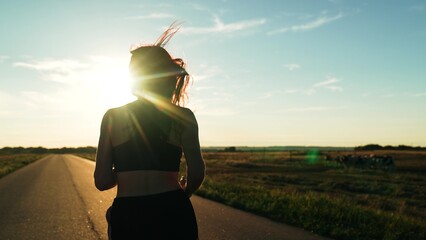 silhouette sports girl running along road sunset, runner fitness training, athlete legs rest,...