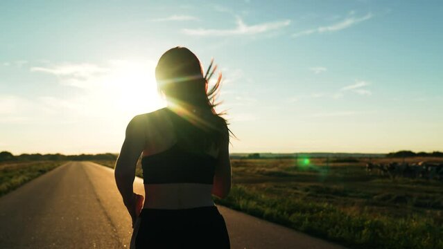 silhouette sports girl running along road sunset, runner fitness training, athlete legs rest, sports runner, wellness, sprint running, sport training, light training, athlete runner training stadium