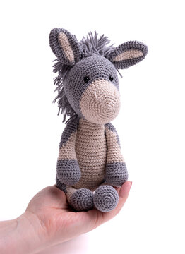 Handmade crochet donkey toy, amigurumi, isolated.