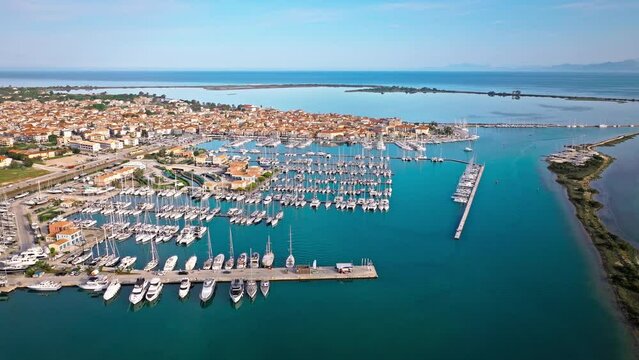 Aerial view of D-Marin Lefkas Marina full of boats and ships in Lefkada. The island's capital and port town with turquoise waters, Greek-style houses with colourful shutters, and wooden balconies.