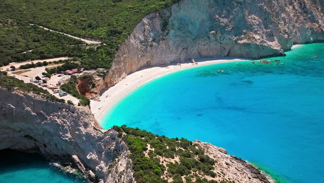 Porto Katsiki beach with turquoise water bordered by concave pale cliffs. Aerial view of crystal clear blue waters with picturesque views on the Ionian island of Lefkada, Greece.