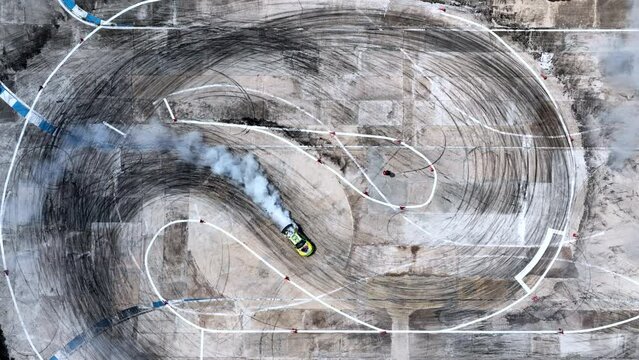 Aerial view professional driver drifting car on race track, Race drift car with lots of smoke from burning tires on speed track, Car with smoke on wheels, Drifting car slow motion.