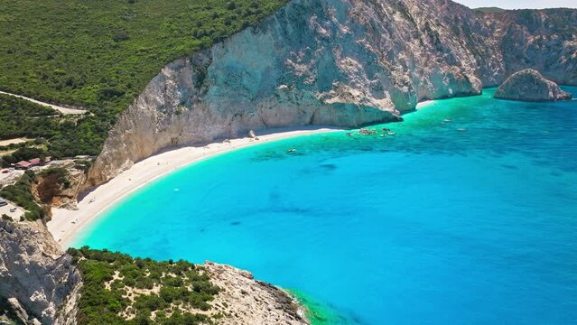 Porto Katsiki beach with turquoise water bordered by concave pale cliffs. Aerial view of crystal clear blue waters with picturesque views on the Ionian island of Lefkada, Greece.