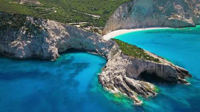 Porto Katsiki beach with turquoise water bordered by concave pale cliffs. Aerial view of crystal clear blue waters with picturesque views on the Ionian island of Lefkada, Greece.