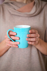 Female hands holding cup of freshly made cacao drink