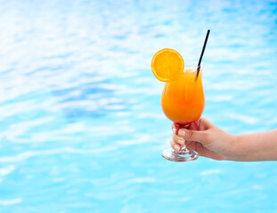 Glass of tropical cocktail on poolside
