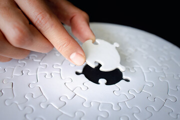 Hand put the last piece of jigsaw puzzle to complete the mission, Business solutions, success and...