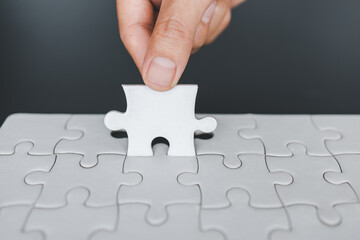  Hand put the last piece of jigsaw puzzle to complete the mission, Business solutions, success and strategy concept, The solution includes completing the mission.