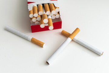 Pack full of filtered cigarettes on white isolated background.