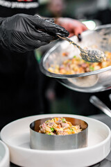 Professional chef cooking Salad Olivier in restaurant kitchen