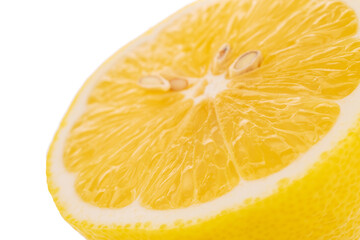 One half of a yellow juicy lemon, close-up, isolated on white.