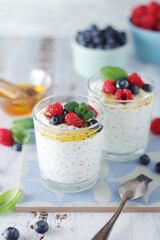 Greek yogurt in glasses with berries and quinoa