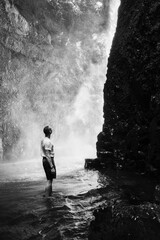 person standing near waterfall
