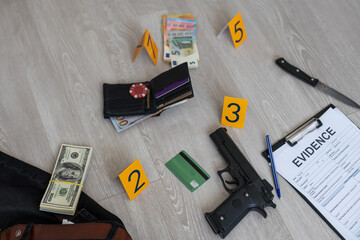 Crime scene investigation - numbering of evidences after the murdering in apartment. Brass knuckle,...