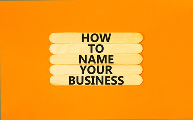 How to name your business symbol. Concept words How to name your business on wooden stick. Beautiful orange table orange background. How to name your business concept. Copy space.