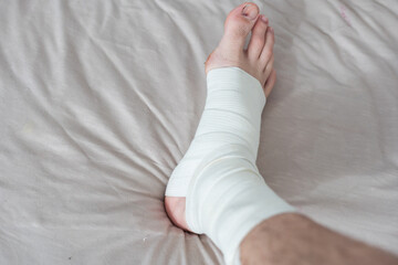 man using put on elastic bandage with legs having leg pain