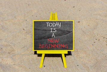 Today is a new beginning symbol. Concept words Today is a new beginning on beautiful blackboard. Beautiful sand beach background. Business today is new beginning concept. Copy space.