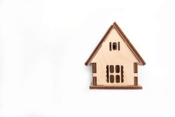 Wooden toy house isolated on white background, property and real estate concept