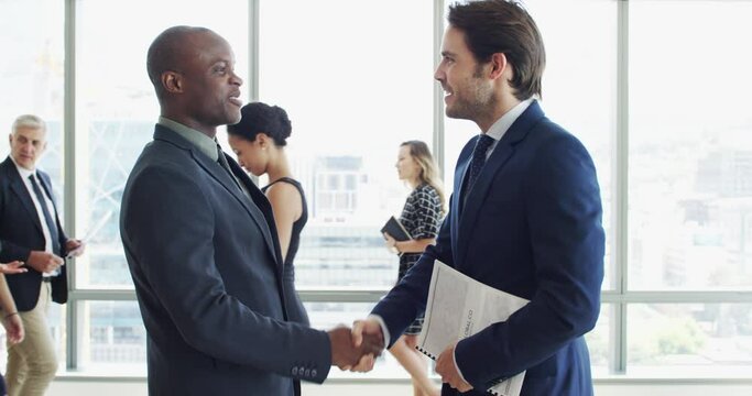 Business people, handshake and meeting in lobby for partnership, professional introduction and hello or greeting. Corporate lawyer, men and clients shaking hands with documents for deal and welcome
