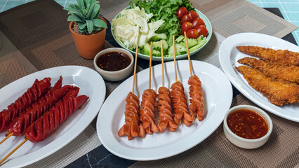 The sausages and fried meatballs made from a variety of meats, mixed with flour and seasonings with a delicious spicy sauce and come with cucumber, cabbage, tomato and lettuce as sides. Street Food.