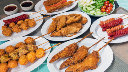 The fried meatballs made from a variety of meats and sausages, mixed with flour and seasonings with a delicious spicy sauce and come with cucumber, cabbage, tomato and lettuce as sides. Street Food.