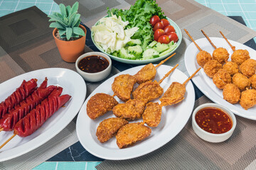 The fried meatballs made from a variety of meats and sausages, mixed with flour and seasonings with a delicious spicy sauce and come with cucumber, cabbage, tomato and lettuce as sides. Street Food.