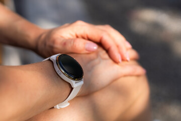 Fototapeta premium Modern sport gadget concept - young woman using a smartband 