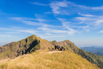 Group of hiking or hiker people stand in mountains and looking the target to go mountain peak at Khao Chang Phuak in Thong Phum National Park, Thailand.