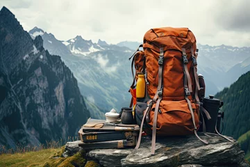 Selbstklebende Fototapeten Backpack and camping equipment on the background of the mountain landscape © Kitta