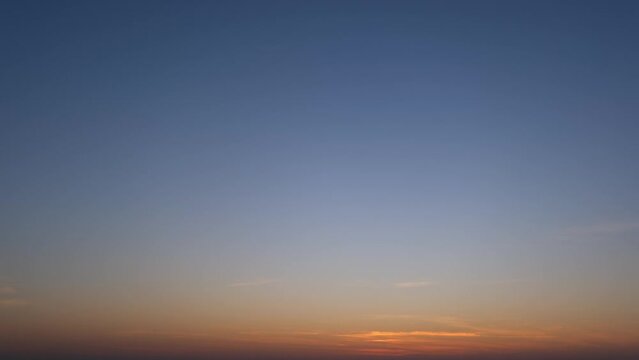 Fast time-lapse unveiled a dynamic sunset sky with swirling clouds. Shades of pink, gold, and lavender merged in a captivating dance, showcasing the fleeting beauty of twilight. Timelapse.
