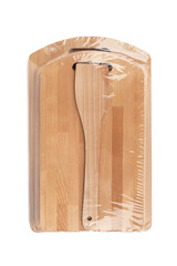 A wooden set of cutting boards and a kitchen spatula is packed in polyethylene.