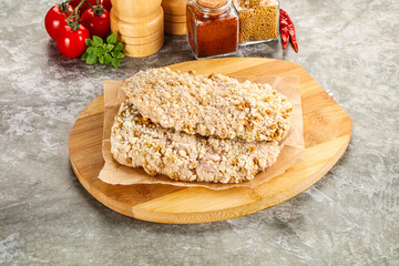 Breaded raw breaded meat schnitzel