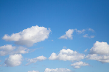 Bright blue sky with many beautiful white clouds for background or wallpaper. The beauty of nature...