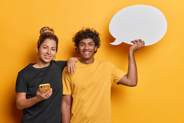 People and happiness. Studio shot of young glad smiling Hindu male holding white speech bubble with...