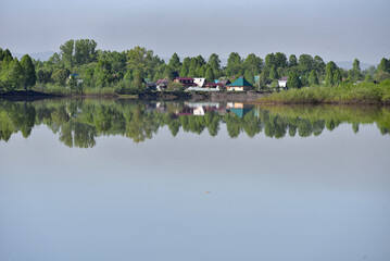 Fototapeta na wymiar Village on the shore of a reservoir in summer.
