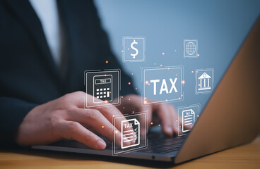 Businessman use laptop to complete Individual income tax return form online for tax payment....