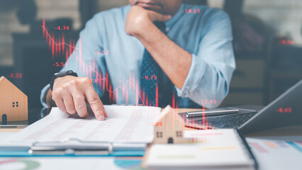 Stocks concept. Stressed businessman, observing a graph with falling stocks, analyzes statistics...