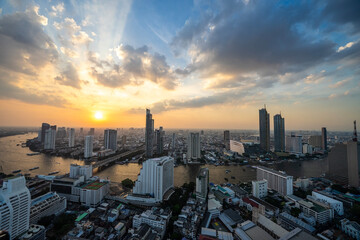 Fototapeta premium Sunset view of the Chao Phraya River with buildings and temples, Bangkok, the capital of Thailand and a tourist destination.