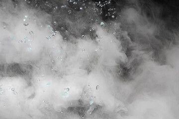 Blurred white water vapor on black background. Abstract isolated water vapor with copy space. Flow of smoke steam on black background.	