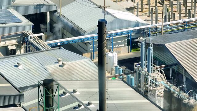 Thick, ominous plumes of industrial plant smoke engulf the skyline, staining the air with a noxious haze, a stark reminder of our battle against air pollution. Industrial emissions concept. Drone.
