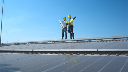 Both of technician working on a photovoltaic solar panels