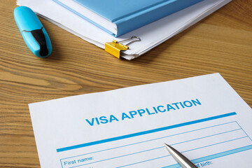 Empty visa application form and pen.