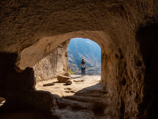Young woman enjoying views in Vardzia cave city in couthern Georgia